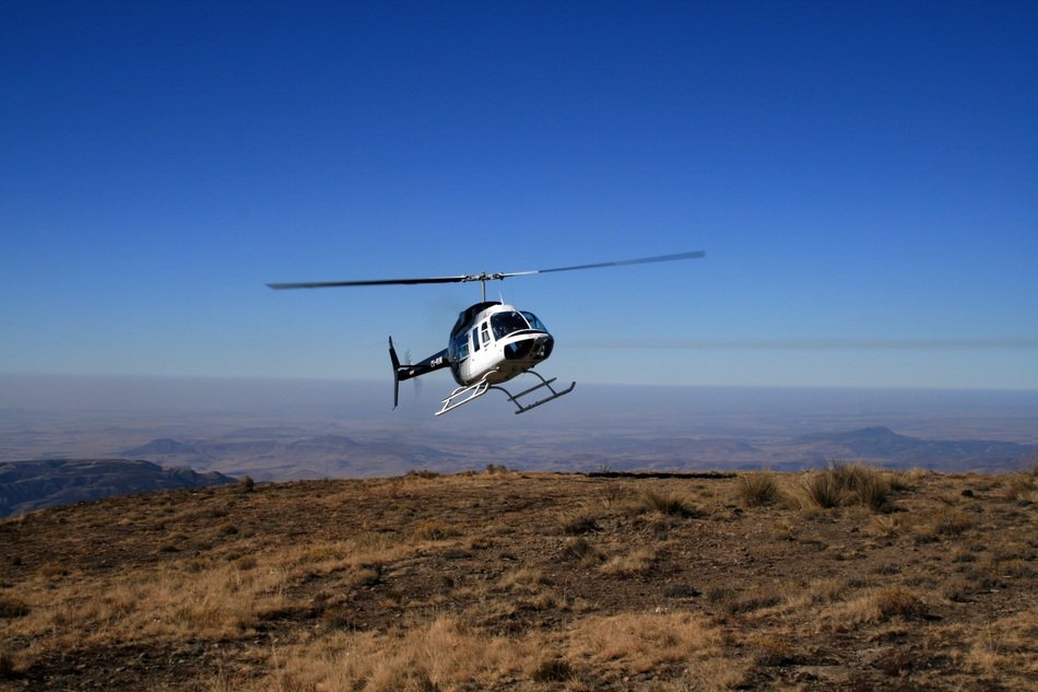 Helicopter flying over the Mountains