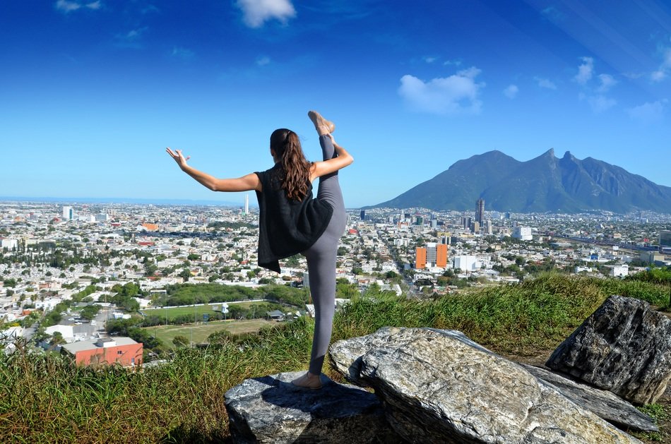 ballerina on the mountain above the cityscape