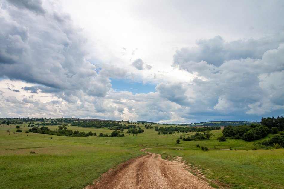 soil Road in summer Landscape under scenic Clouds, bulgaria