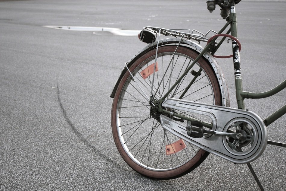 part of a bicycle with a wheel on a gray background on the road