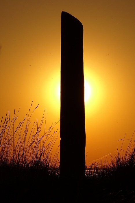 setting sun behind the pillar