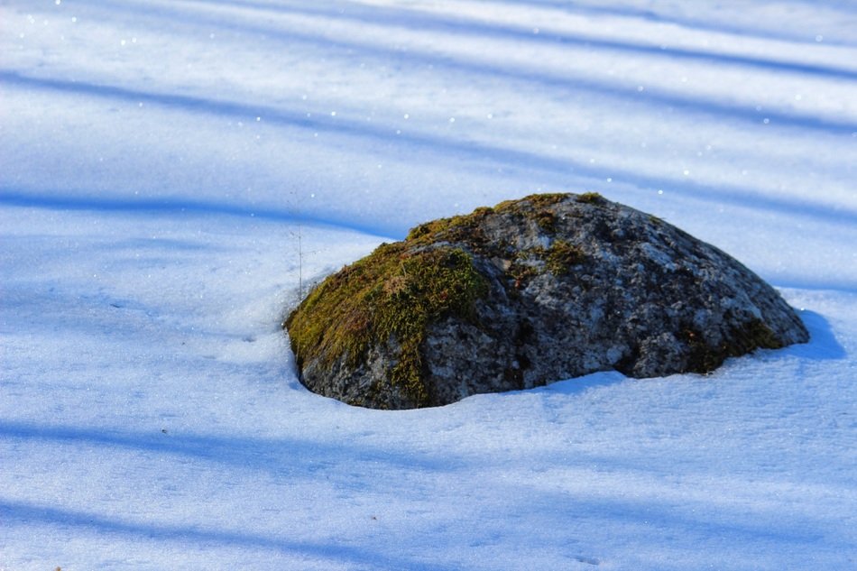 stone in the middle of the snow