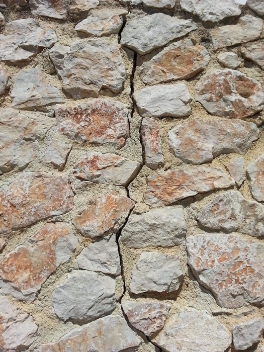 Photo of cracked stone wall