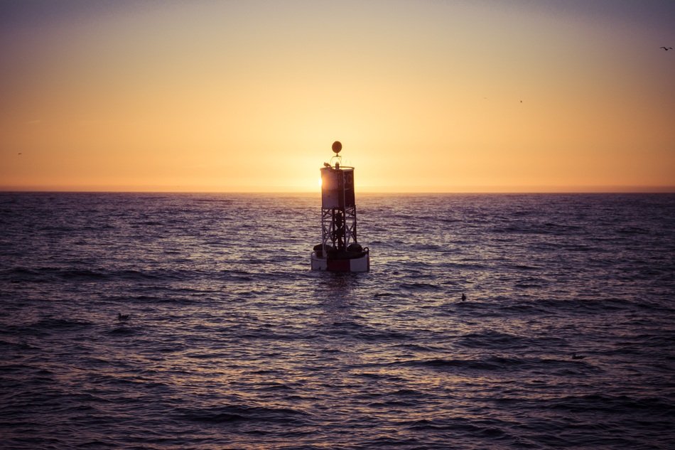 ocean buoy at sunset
