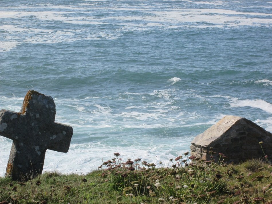 cross on the wild coast of the atlantic ocean