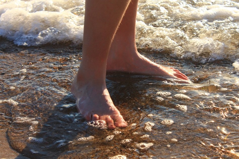 feet in the foamy surf of the Baltic Sea