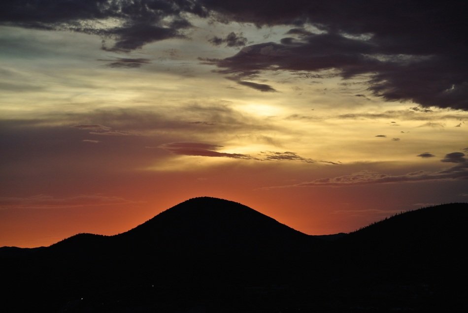 dramatic Sunset Sky above dark Mountains