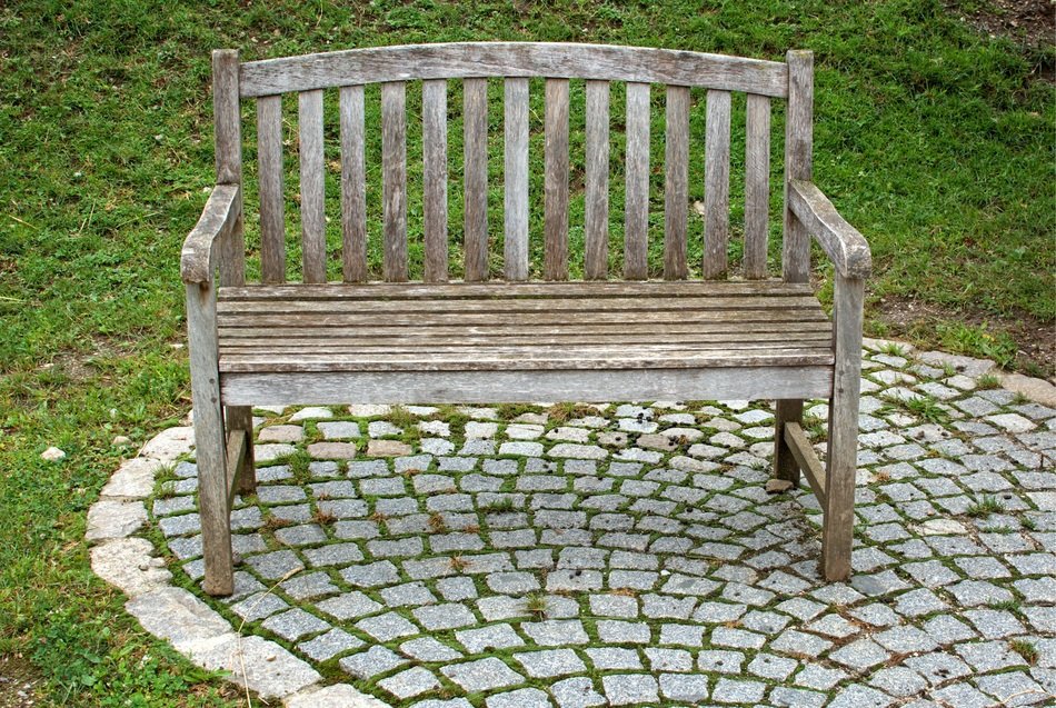 wooden bench on a white tile in the park