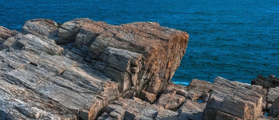 rocks on the shore of the blue sea in Canada