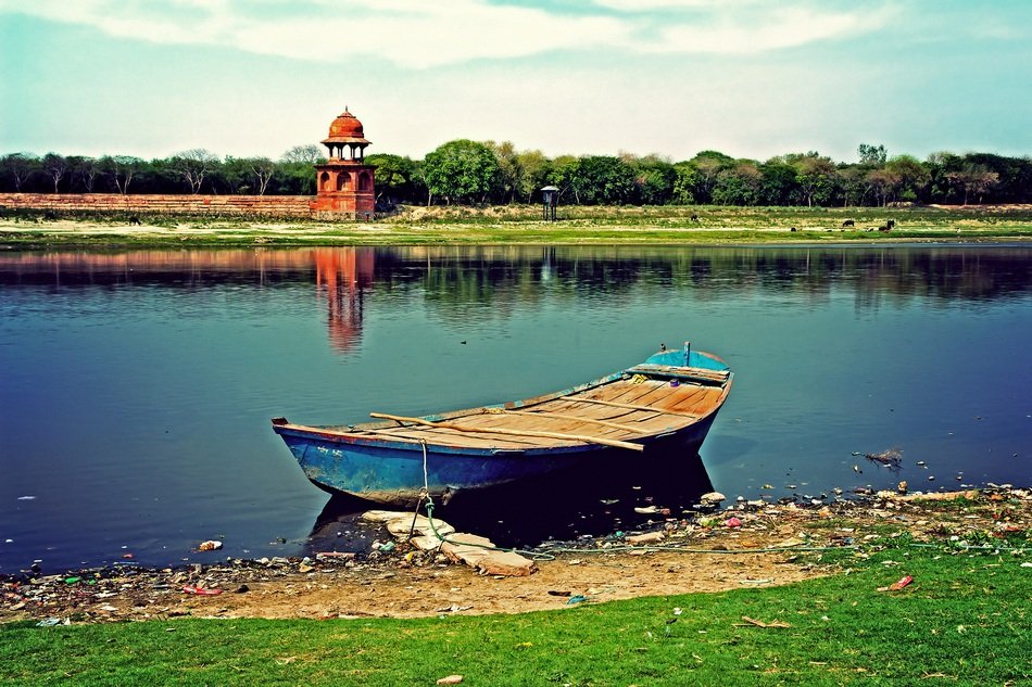 wooden boat on the banks of the jamuna river in india