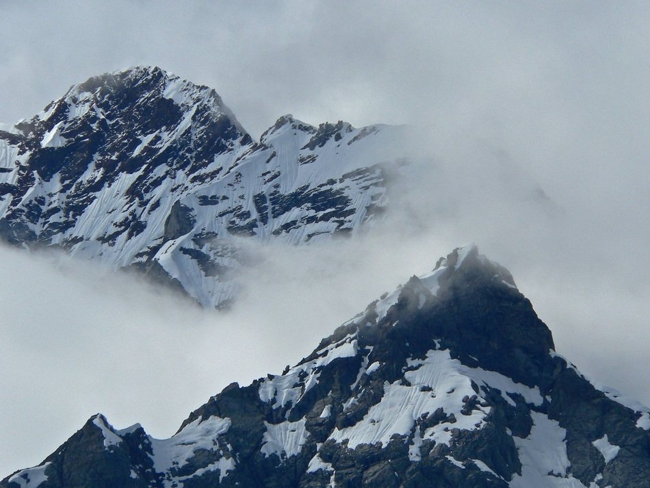 rocky peaks in clouds in alaska