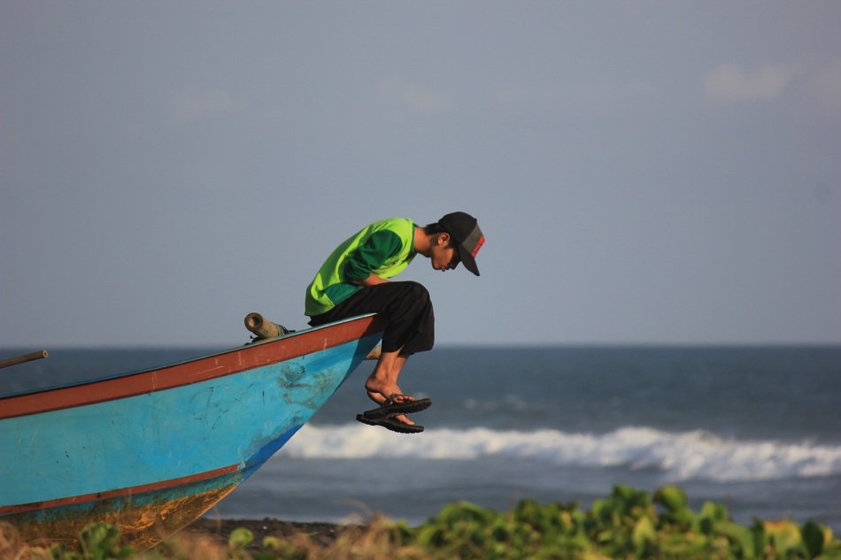 Male sitting on a ship