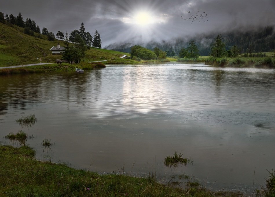 sun rays reflected in the evening lake