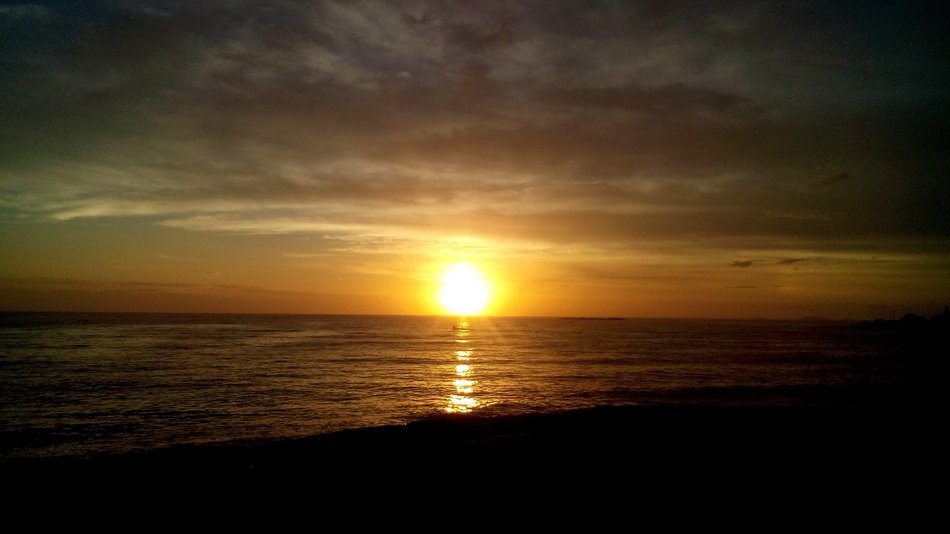 bright colorful evening sun on the horizon over the water