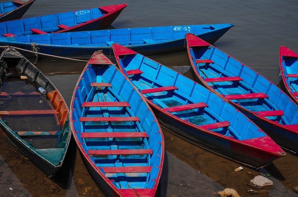 blue boats on a lake in Nepal