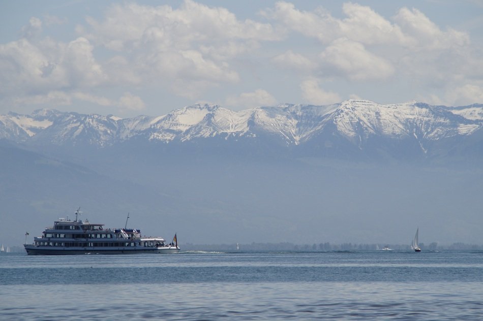 ship on Lake Constance amid snow-capped mountains