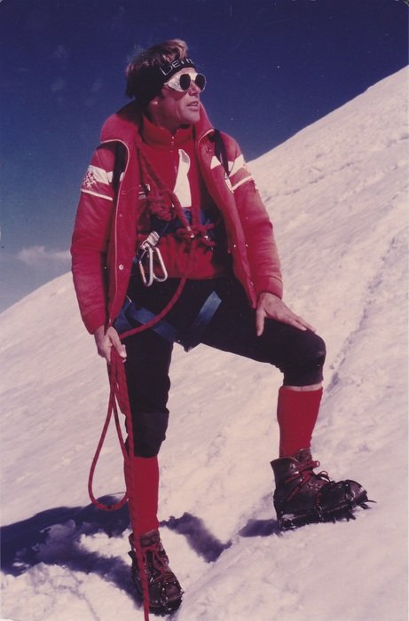 mountain guide in a fashionable suit on a sunny day