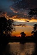 clouds in orange sunset over a picturesque landscape