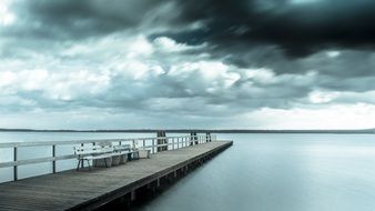 wooden pier on the lake on a rainy day