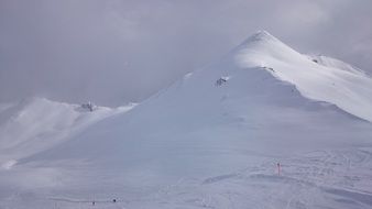 Snow Domes of Alpine Mountains at cloudy sky, italy, tyrol