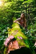 Girl near the tree with the moss