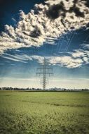 power lines on the background of white fluffy clouds