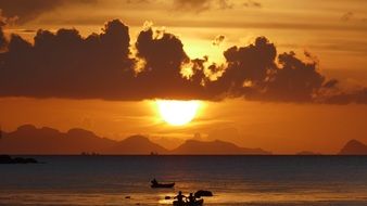 fisher boats in the sea at the sunset