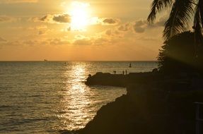 people Fishing on sea coast at sunset, Cuba, Havana