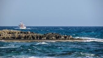 distant view of a boat off the coast, cyprus, ayia napa
