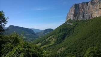 Limestone cliff above forested mountain, france, Vercors Massif