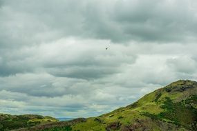 cloudy sky over green hills at Holyrood Park in Edinburgh
