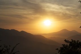 bright sun over the mountains at dusk