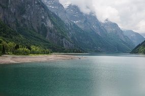Lake Geneva among high mountains in the clouds