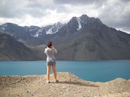 girl admires the mountains in chile