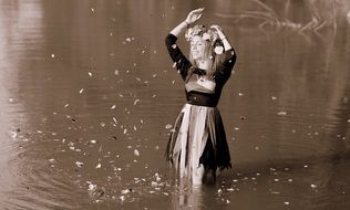woman with wreath standing in the water
