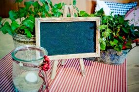 Table easel, candle and flowers in pots