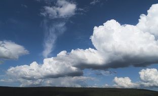 blue sky with huge white clouds on a sunny day