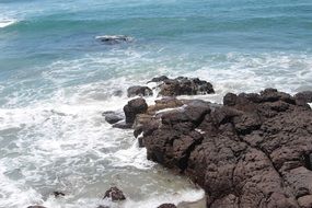 ocean waves beat against the rocks