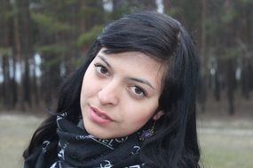 Brunette in the forest near the pines