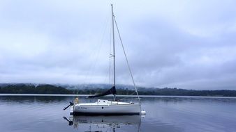 white yacht on the lake on a cloudy day