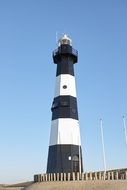 black-white lighthouse on the north sea coast on a sunny day