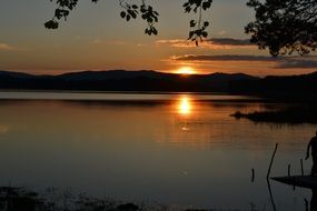 sun at sunset on the horizon of a lake