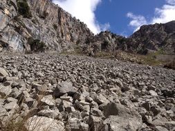 small stones at the foot of the cliff