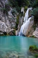 beautiful natural waterfall falling from high rock