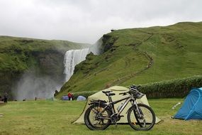 tourist parking near a waterfall in iceland