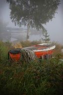 red boat on green grass