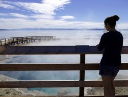 girl over geothermal springs in Yellowstone National Park