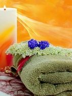 towel, candle and flowers