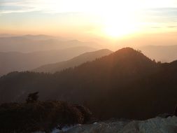 sunlight on the horizon beyond the mountains