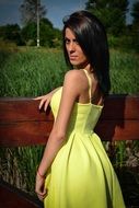 girl in yellow dress posing at the paddock